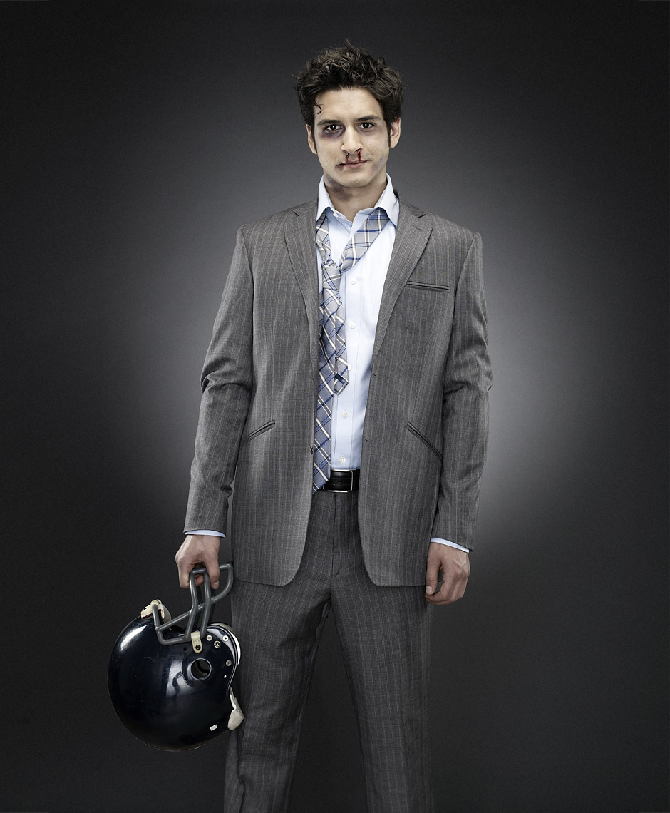 Business man with football gear and bruises